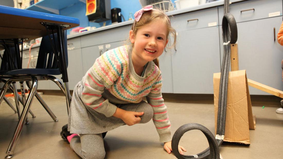 Elementary school aged girl working on an experiment at the Fleet Science Center