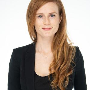 A red headed woman in a black outfit 