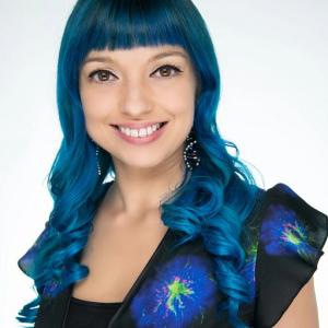 A woman with blue hair in a black and blue outfit 
