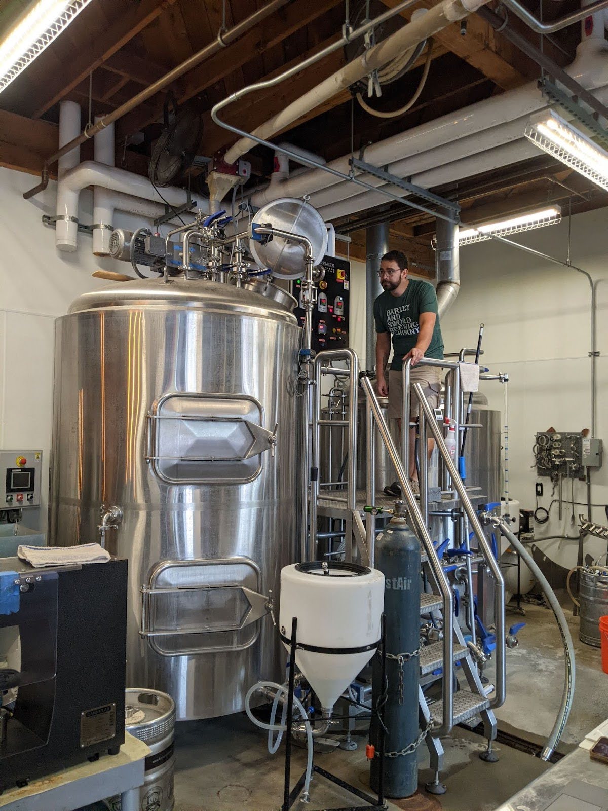 Man monitoring a brew in a brewery.