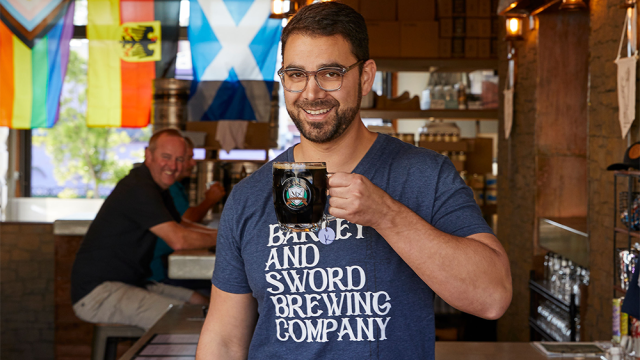 Man holding a beer.