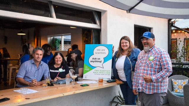 Science professionals gathered for Two Scientists Walk Into a Bar outdoors