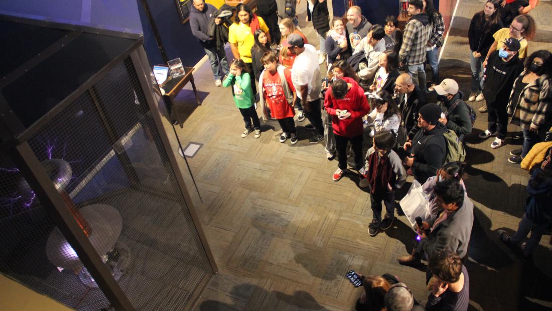 A crowd gathered around a tesla coil