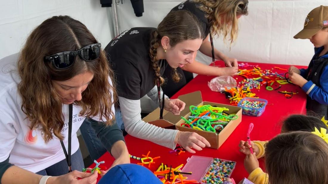 SDSU Center for Autism. People engaging with the public making felt neurons.