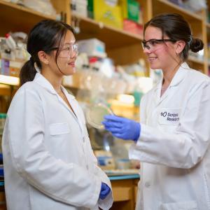 Two scientists from Scripps Research in a lab setting