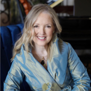 A portrait of woman on a light blue suit smiling