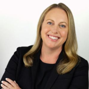 A smiling woman on a dark suit.